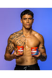 Muscular man holding two 'Pump' supplement containers against a blue background